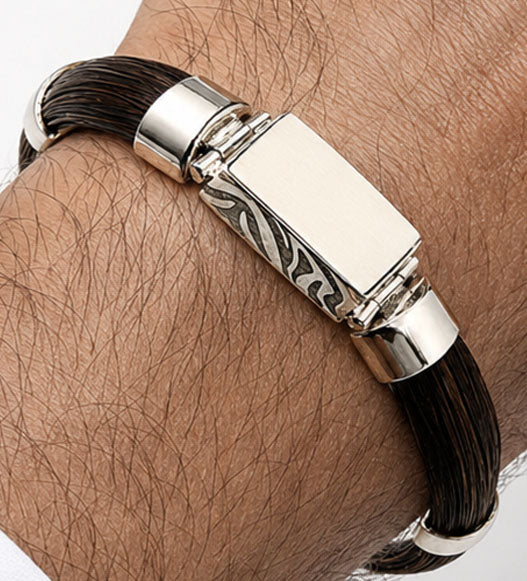 pulsera pelo de faochero africano natural en forma media caña con centro rectangular colmillo natural en plata de ley en la muñeca del modelo