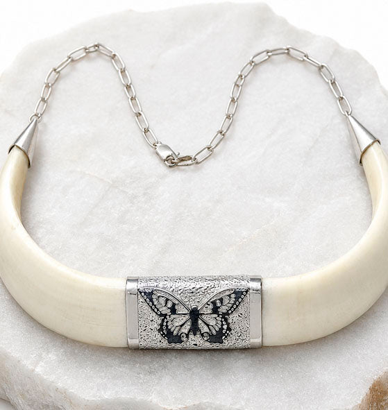 wild boar tusk and silver butterfly necklace